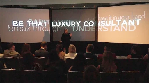 Tammy Cohen speaking in front of the 3 big screens